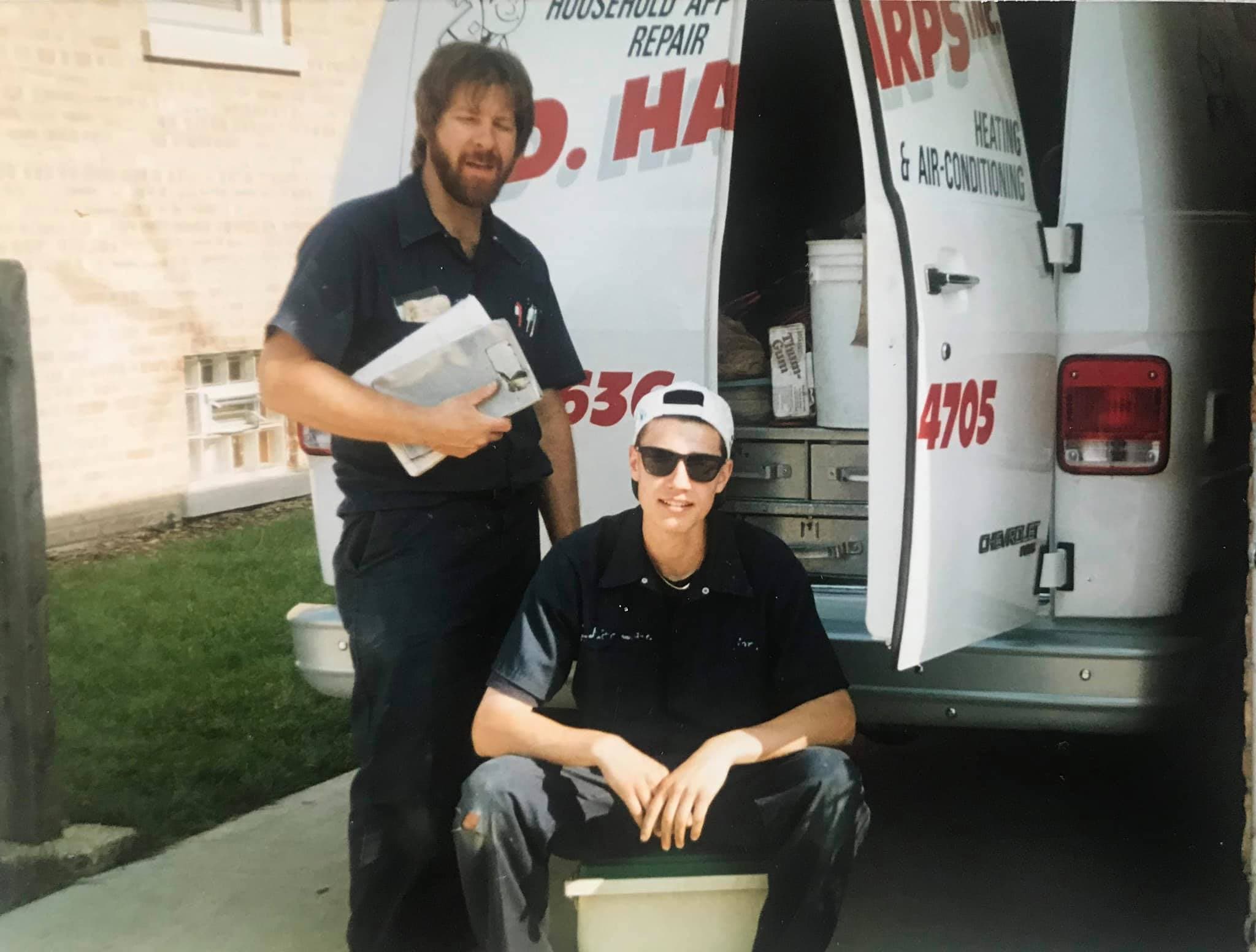 Jim Harps and a young Mark Harps in the late 1980s, beside an early J.D. Harps service van