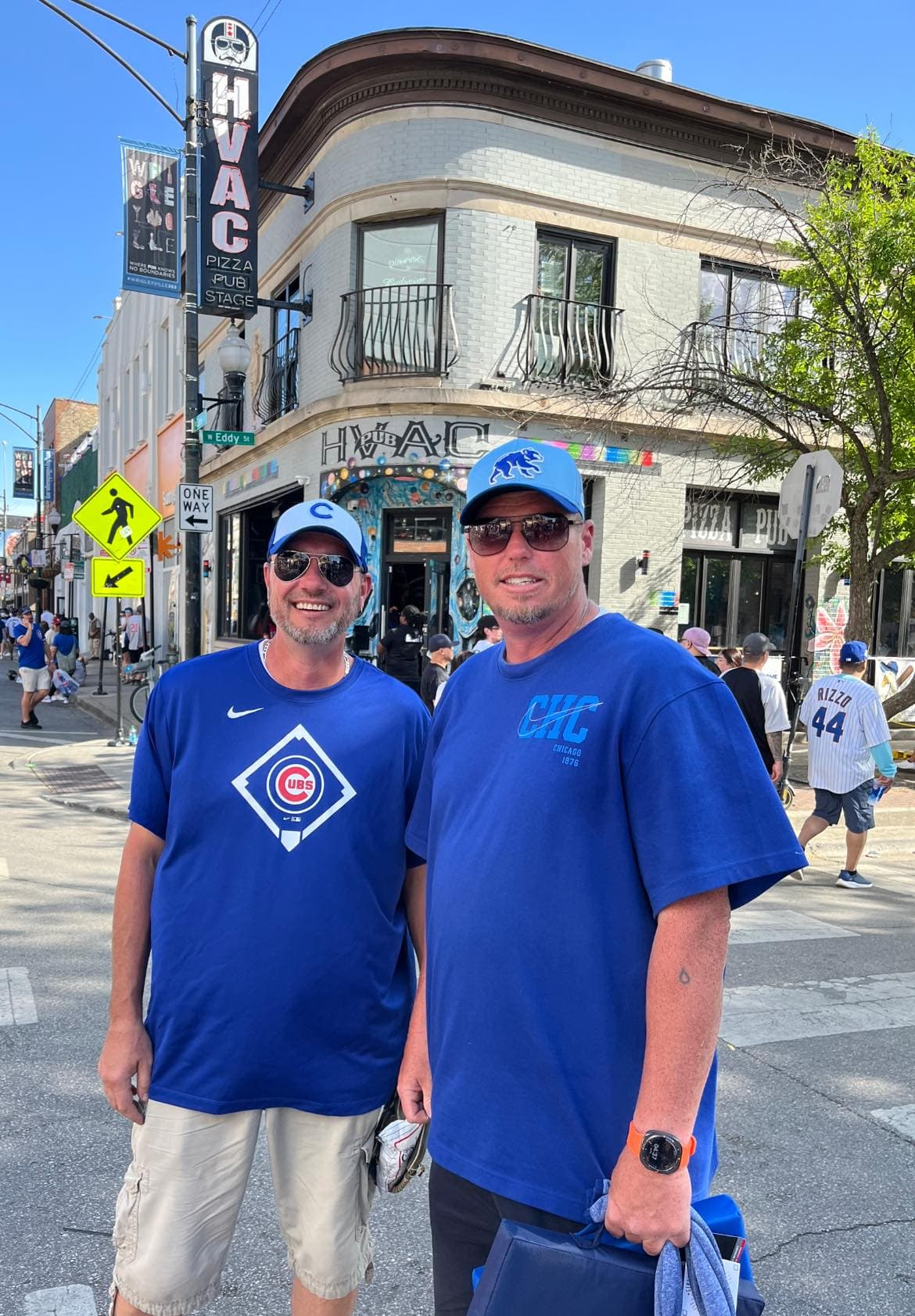 Mark, owner of J.D. Harps, and Eric, lead technician, in Cubs gear outside the HVAC Pub in Wrigleyville, Chicago